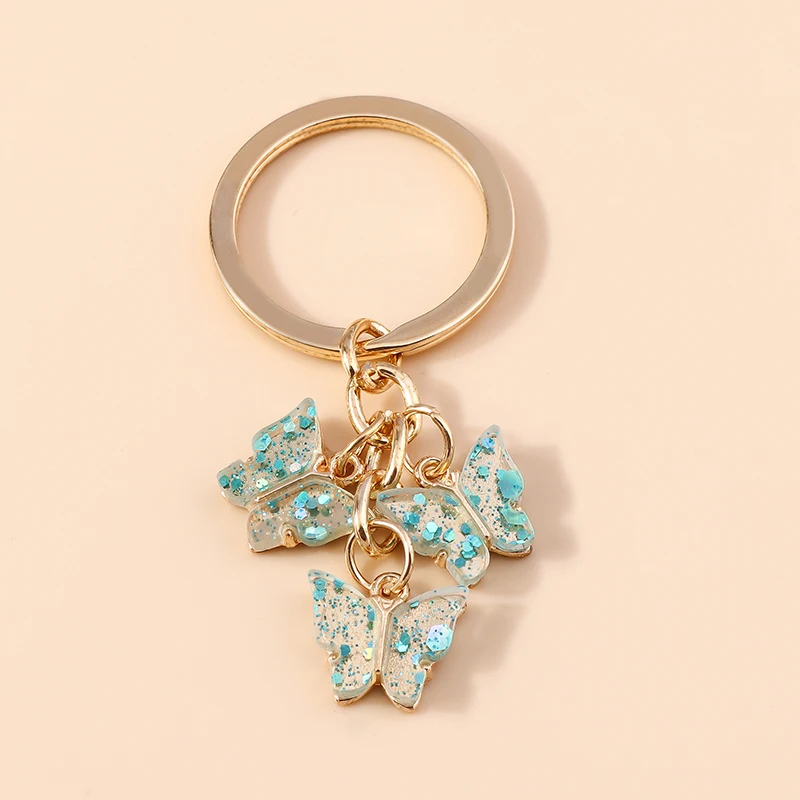 Porte-clés papillon en résine transparente avec paillettes - Couleur Bleu