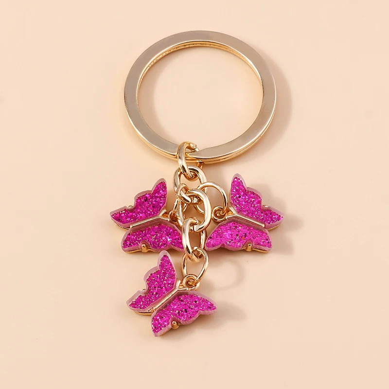 Porte-clés papillon en résine colorée avec paillettes - couleur Rose