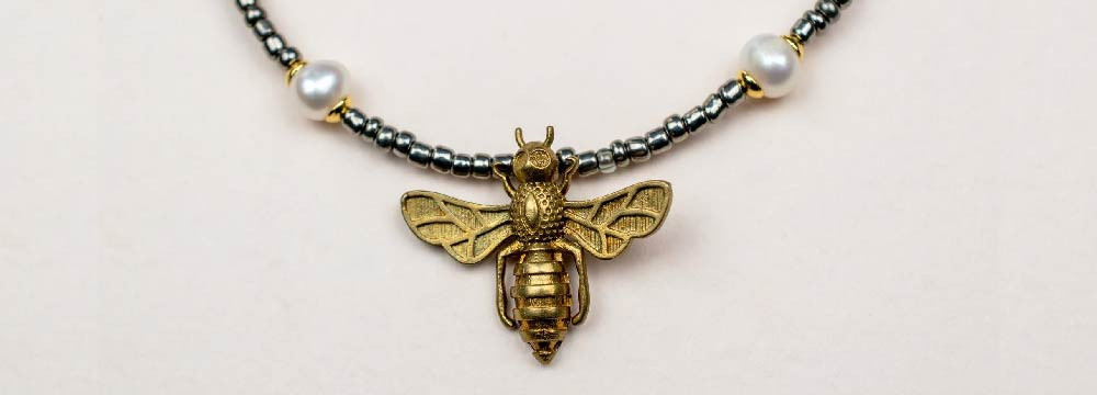 Collection of bee necklaces and bee pendants
